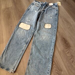 Light Wash Blue Distressed Jeans with Patch Detail